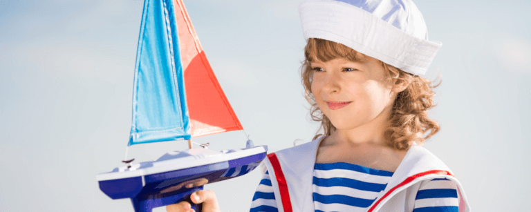 Kid with toy sailboat