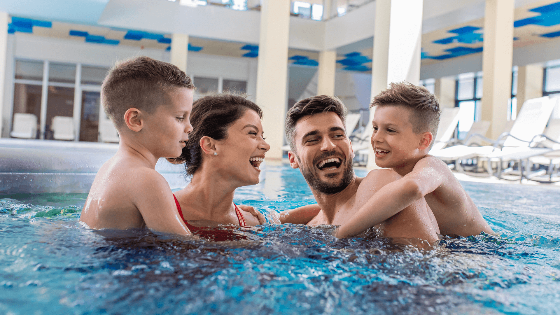 family together in the pool